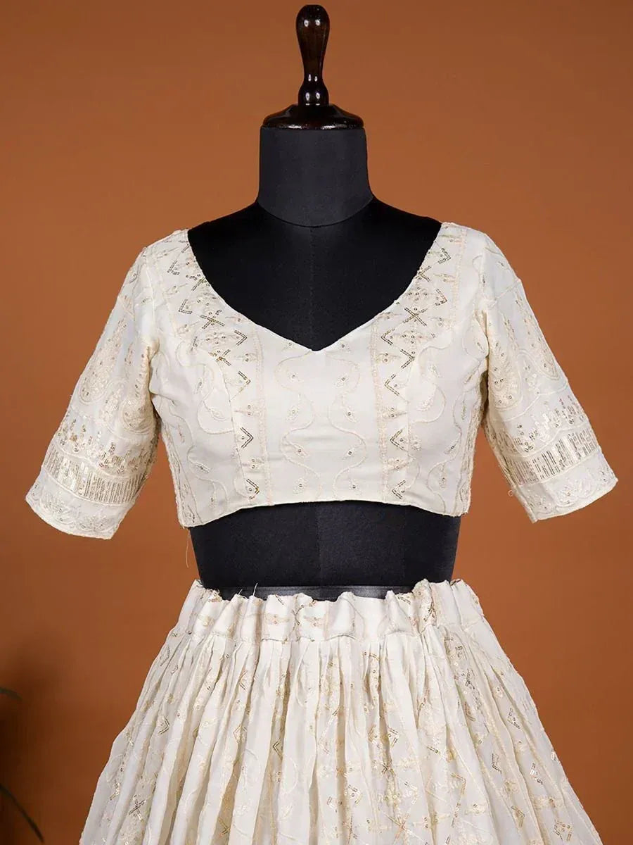 Cream embroidered lehenga choli with V-neck blouse and pleated skirt, ideal for Indian ethnic wear