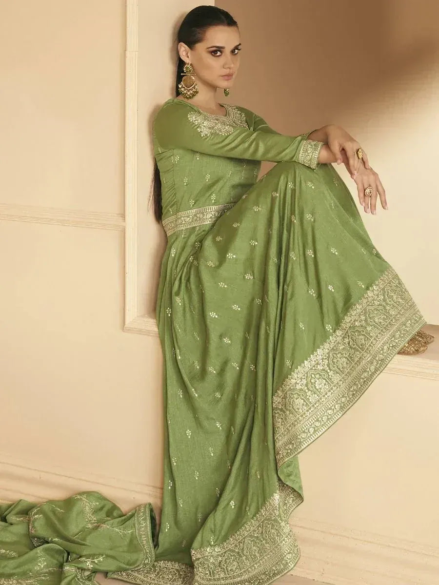Olive green ethnic gown with gold embroidery, perfect for Indian occasions and festive wear.