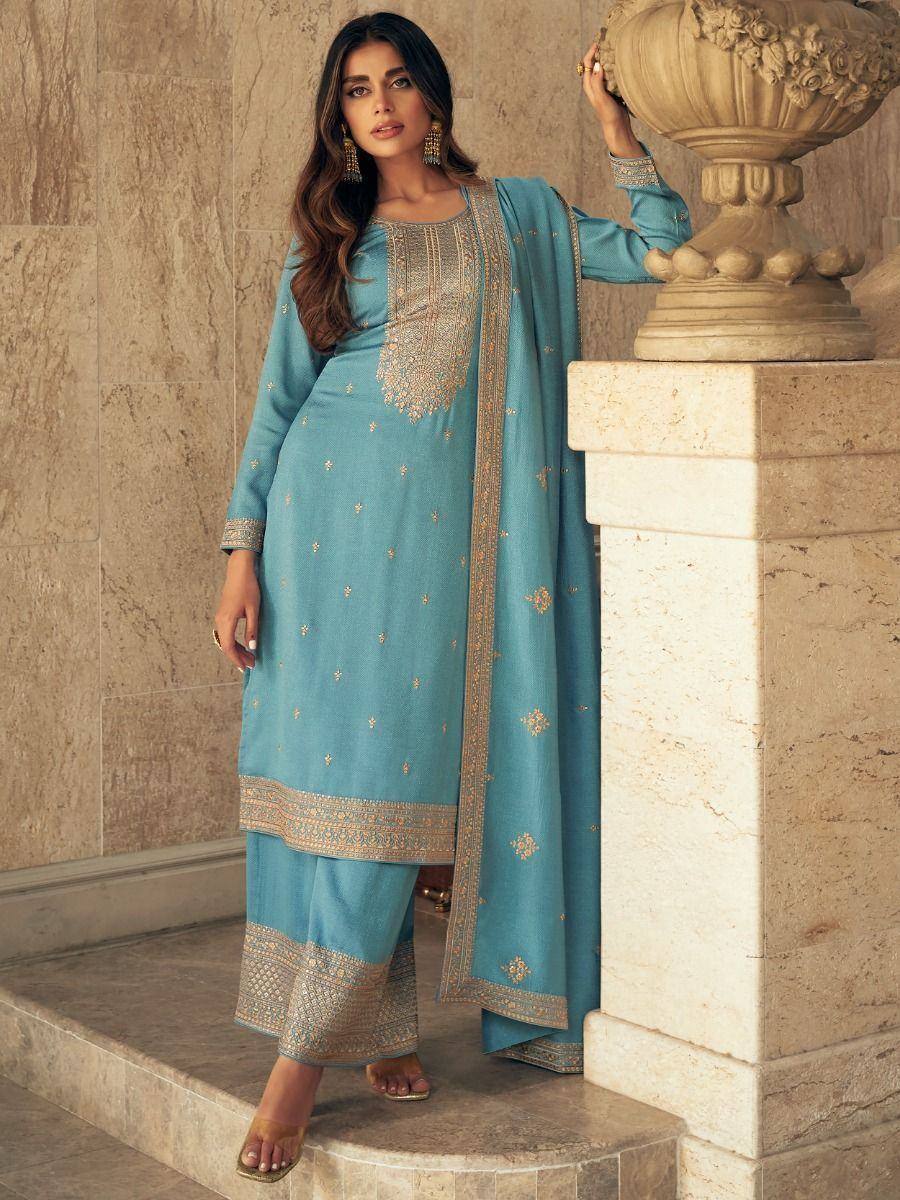 Turquoise embroidered salwar kameez with gold detailing, perfect for ethnic occasions