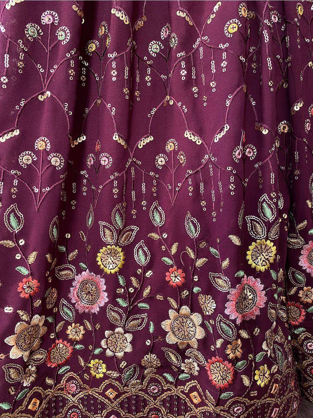 Rich maroon ethnic gown with floral embroidery and sequin detailing for festive occasions