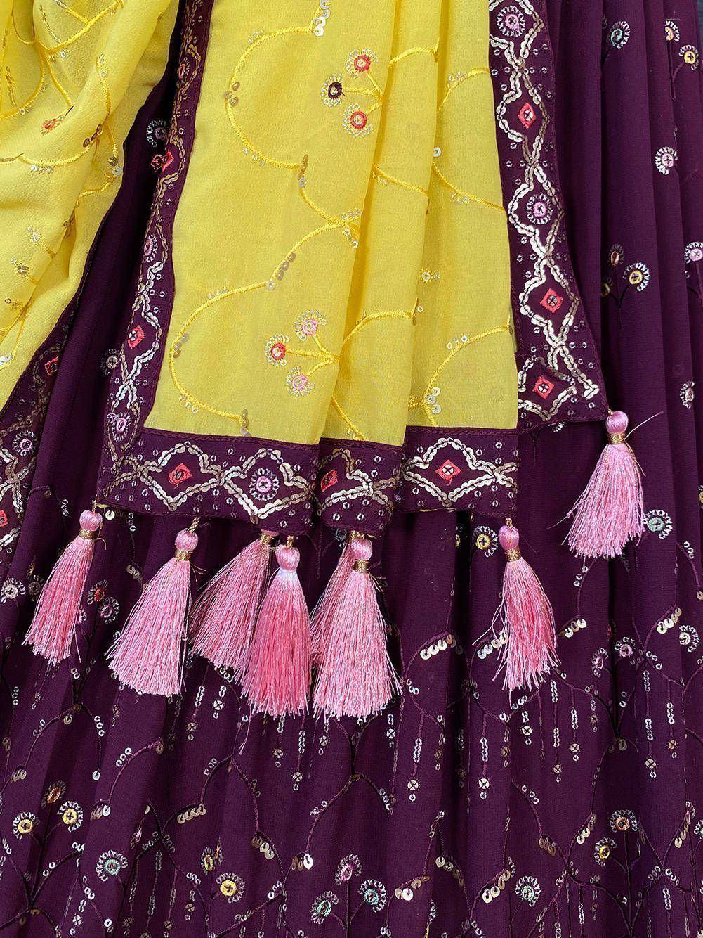 Yellow and purple embroidered lehenga choli with pink tassels, floral sequin detailing, perfect for Indian ethnic wear.