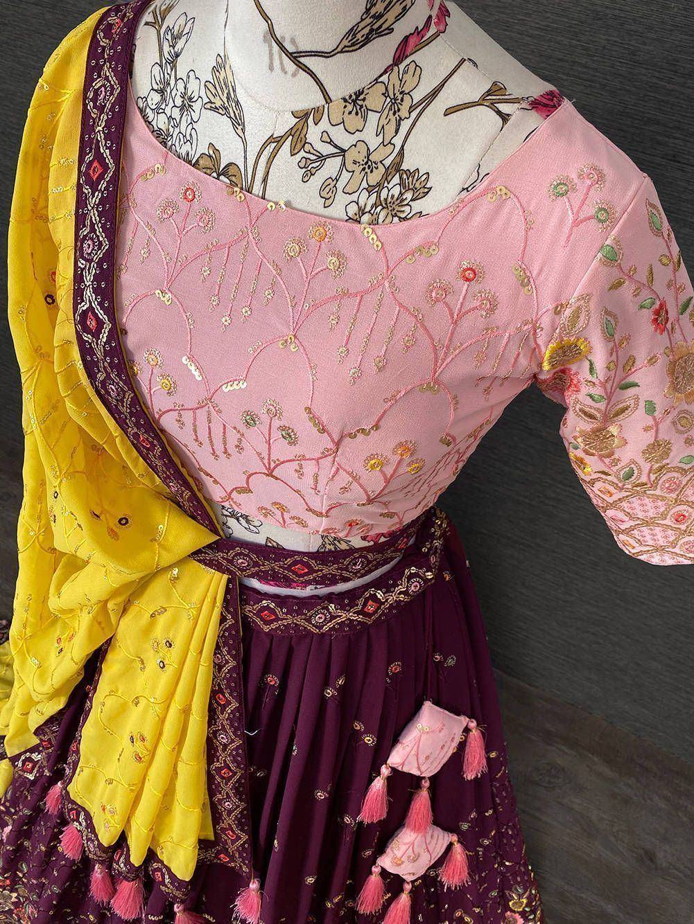 Pink embroidered lehenga choli with yellow dupatta, floral embroidery, and tassels for Indian ethnic wear