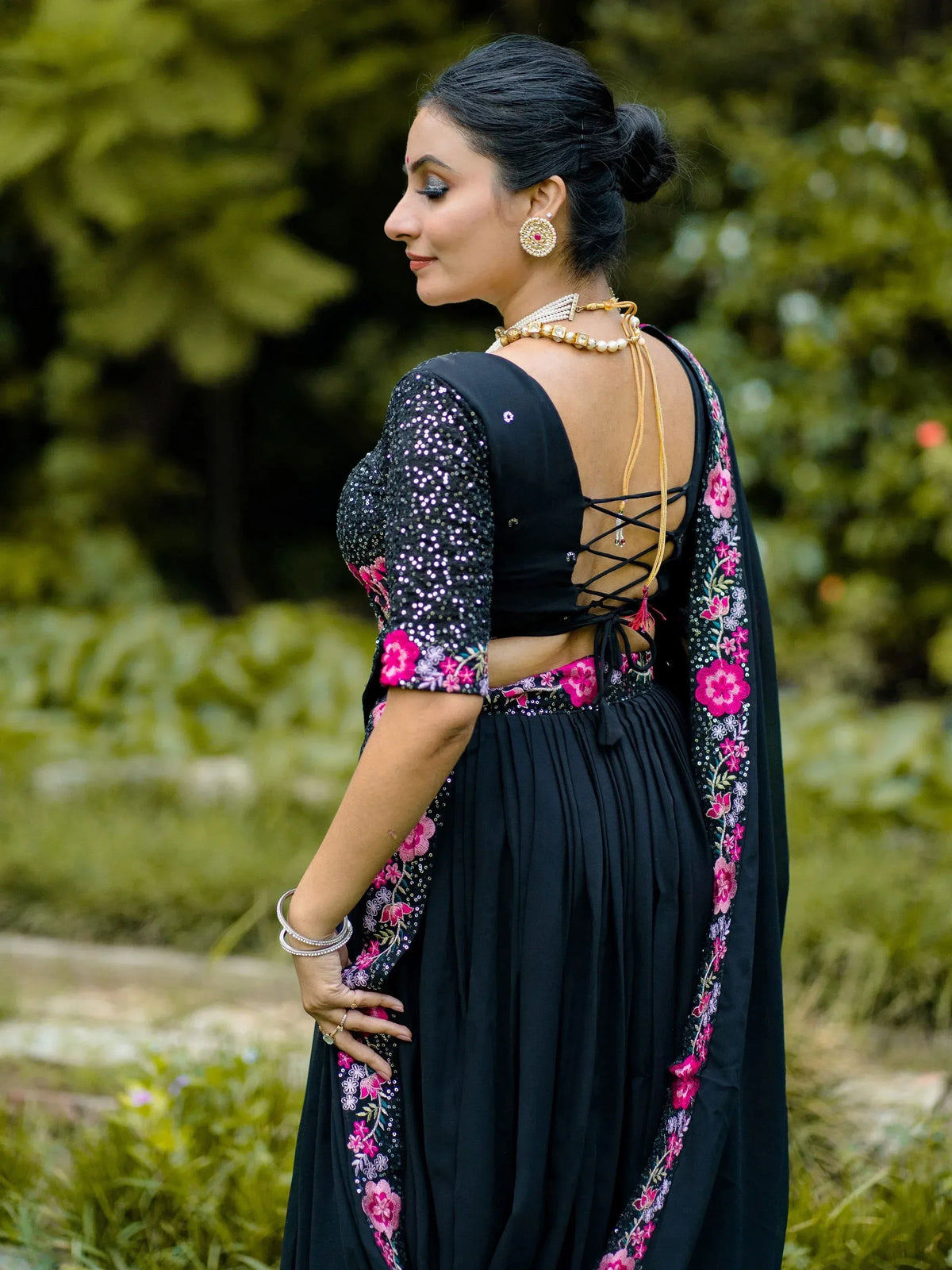 Black floral embroidered ethnic gown with sequin sleeves and lace-up back, perfect for Indian occasions.