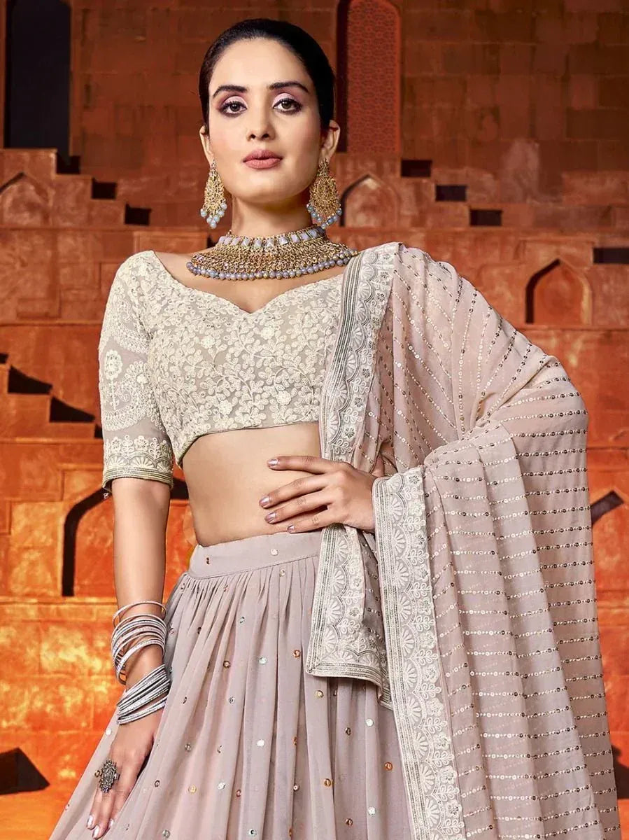 Elegant beige embroidered lehenga choli with sequin dupatta, perfect for Indian ethnic occasions.