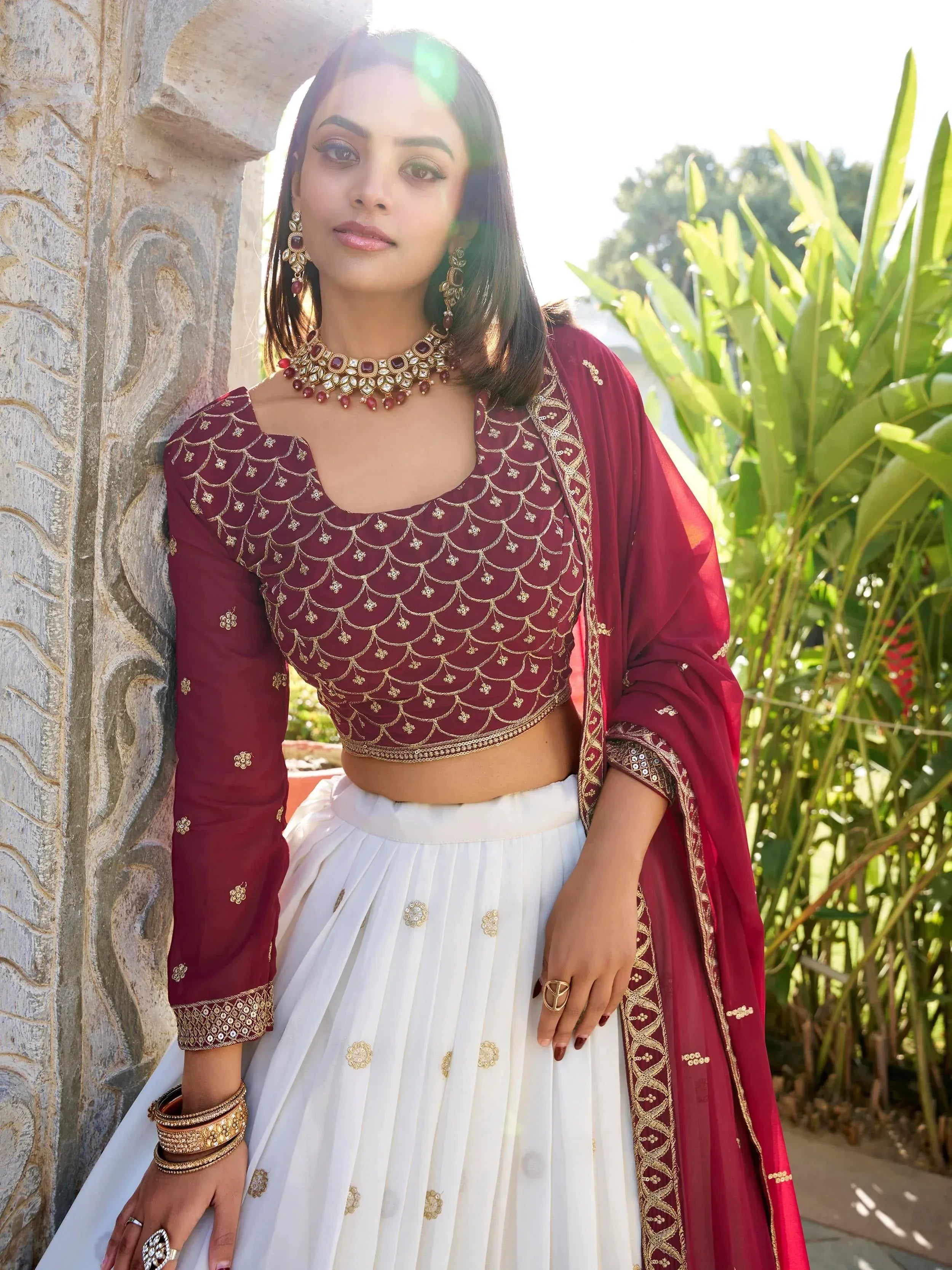 Maroon and white embroidered lehenga choli with gold detailing, perfect for Indian ethnic wear occasions