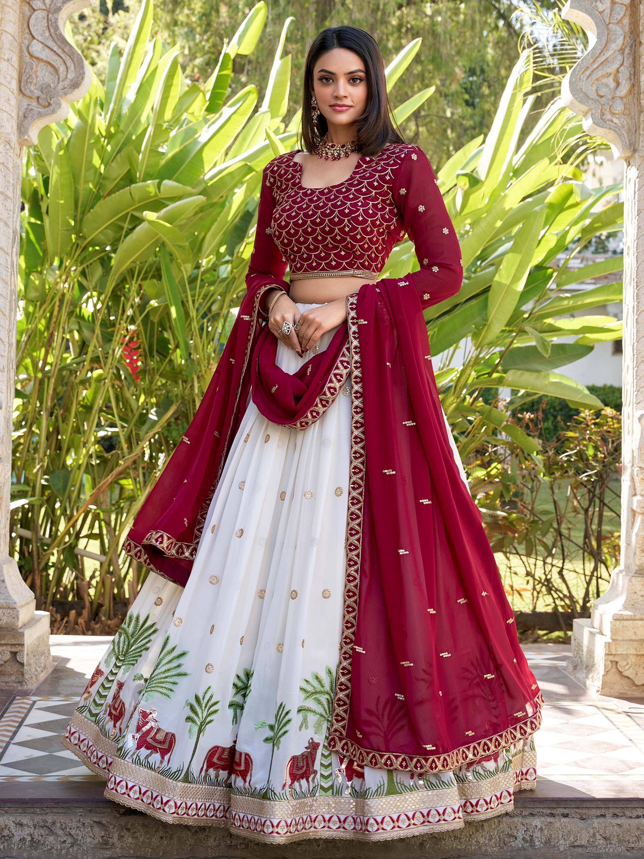 Maroon and white embroidered lehenga choli with gold detailing, perfect for Indian weddings and festive occasions.