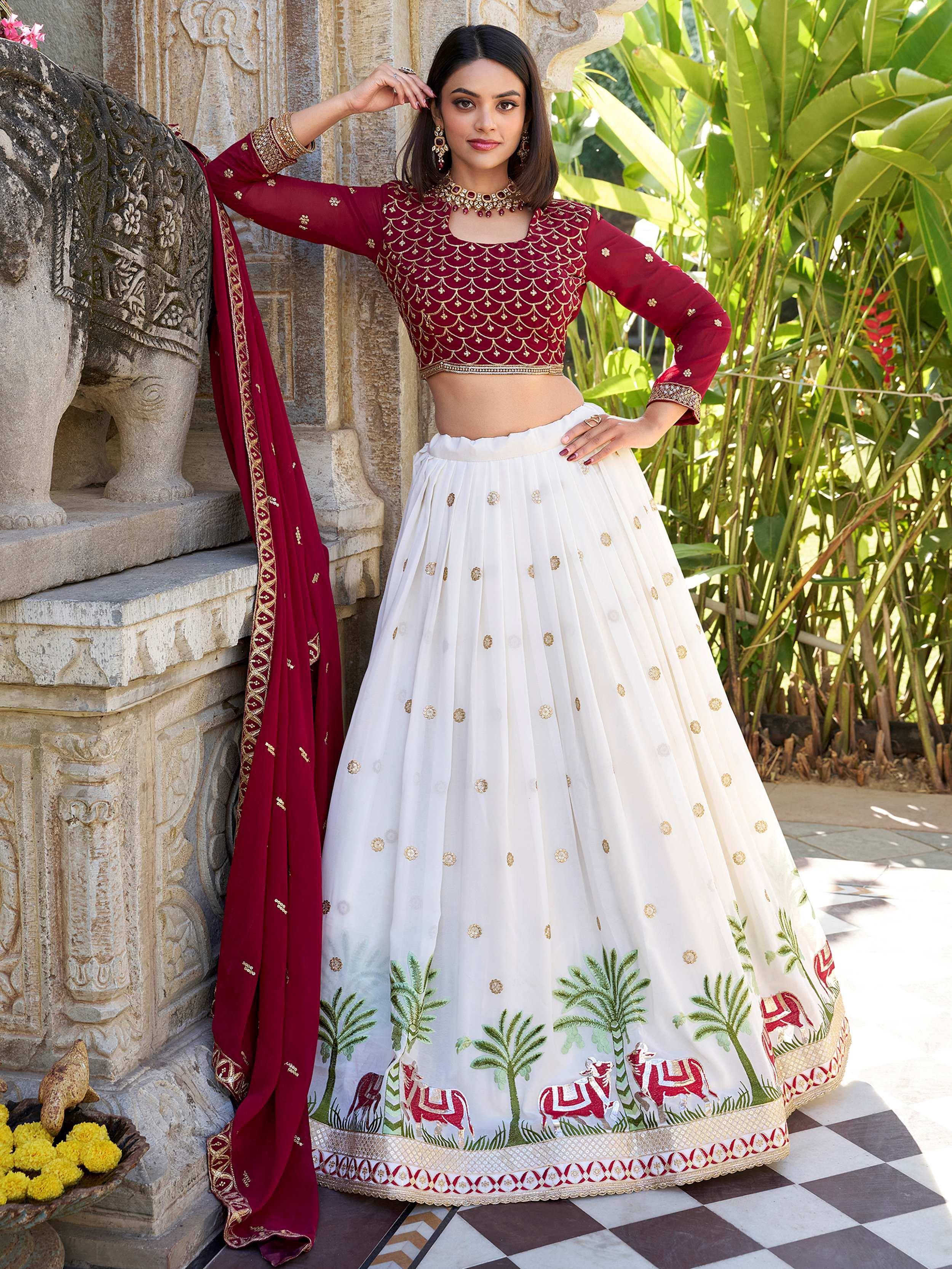 Maroon and white embroidered lehenga choli with gold detailing, palm tree and elephant motifs, perfect for Indian ethnic occasions.