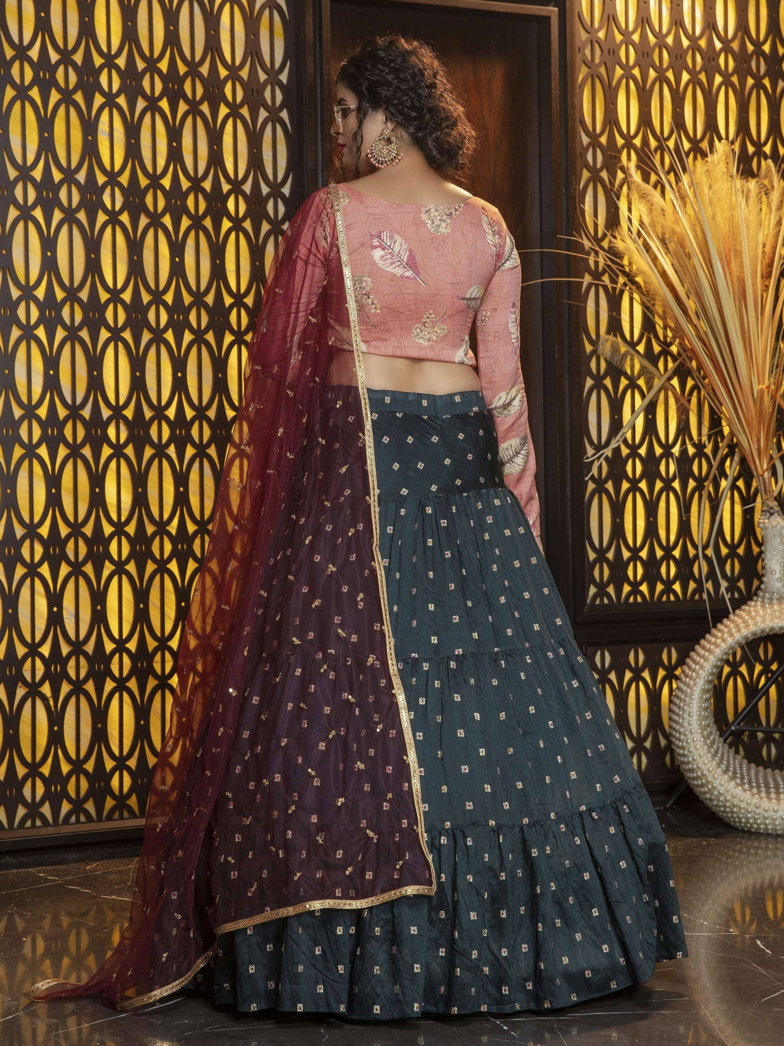 Woman in designer lehenga choli with leaf print blouse, tiered skirt, and maroon dupatta, ethnic wear