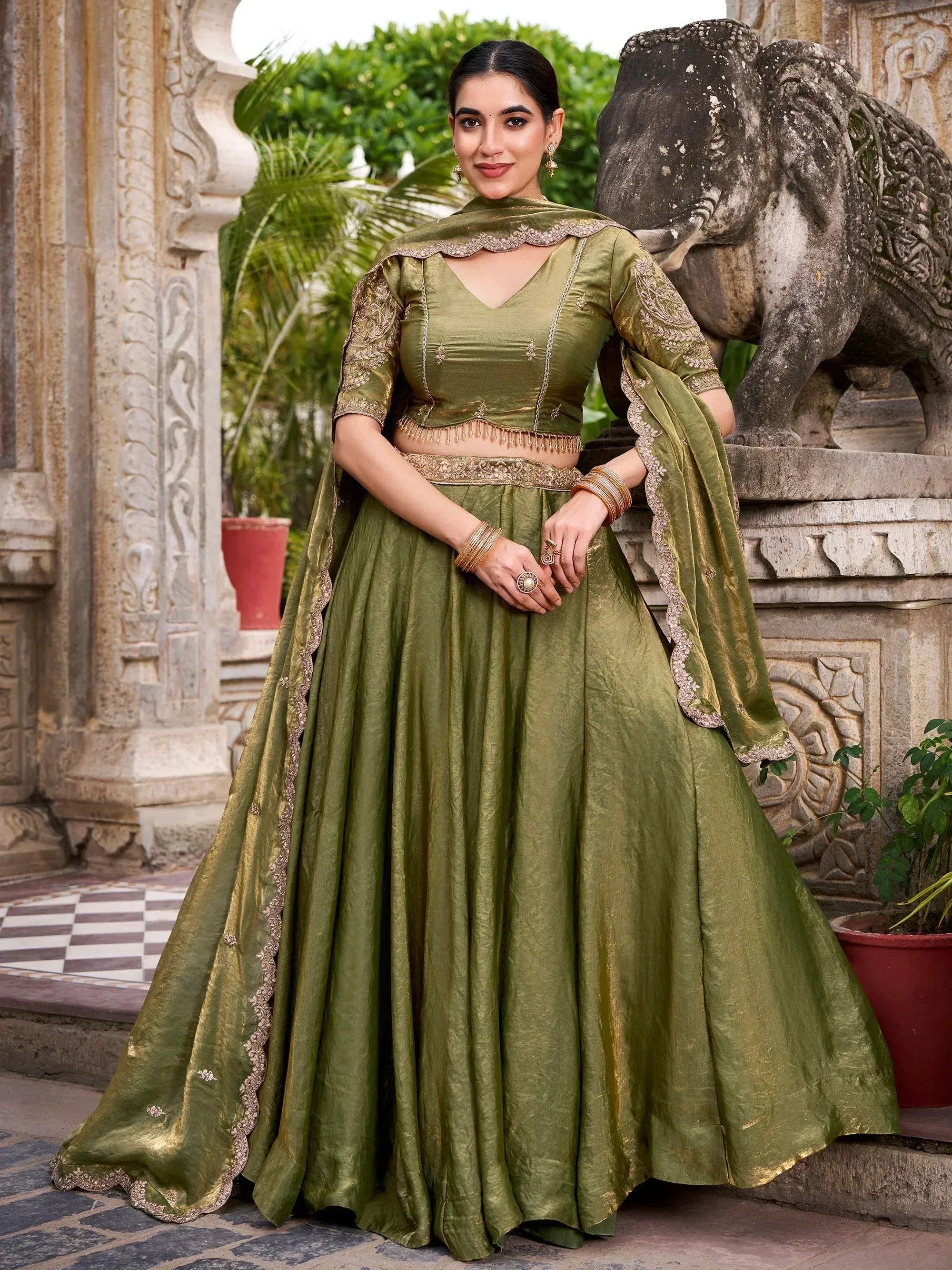 Olive green designer lehenga choli with gold embroidery, perfect for Indian ethnic wear and festive occasions.
