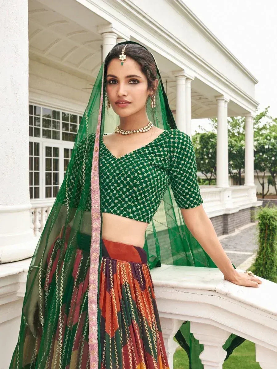 Green embroidered lehenga choli with colorful skirt and dupatta, styled for ethnic wear occasions