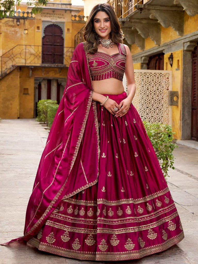 Magenta designer lehenga choli with gold embroidery, perfect for Indian weddings and festive occasions.