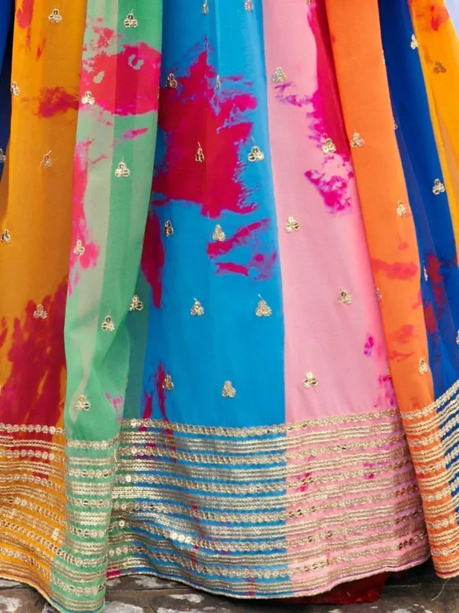 Vibrant tie-dye lehenga with gold embroidery and colorful panels, perfect for festive Indian wear