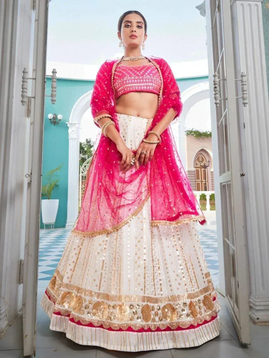 Pink and white designer lehenga choli with gold embroidery, perfect for weddings and festivals