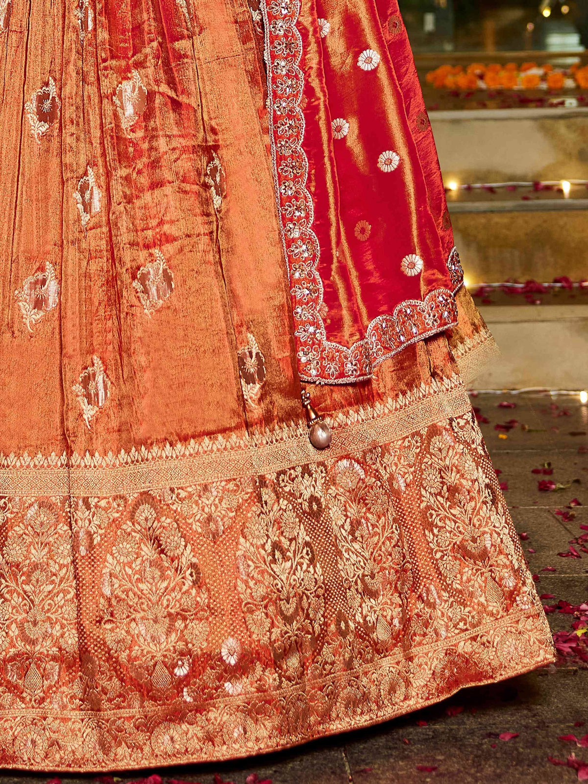 Red and gold embroidered lehenga choli with floral motifs and scalloped dupatta border, festive Indian ethnic wear