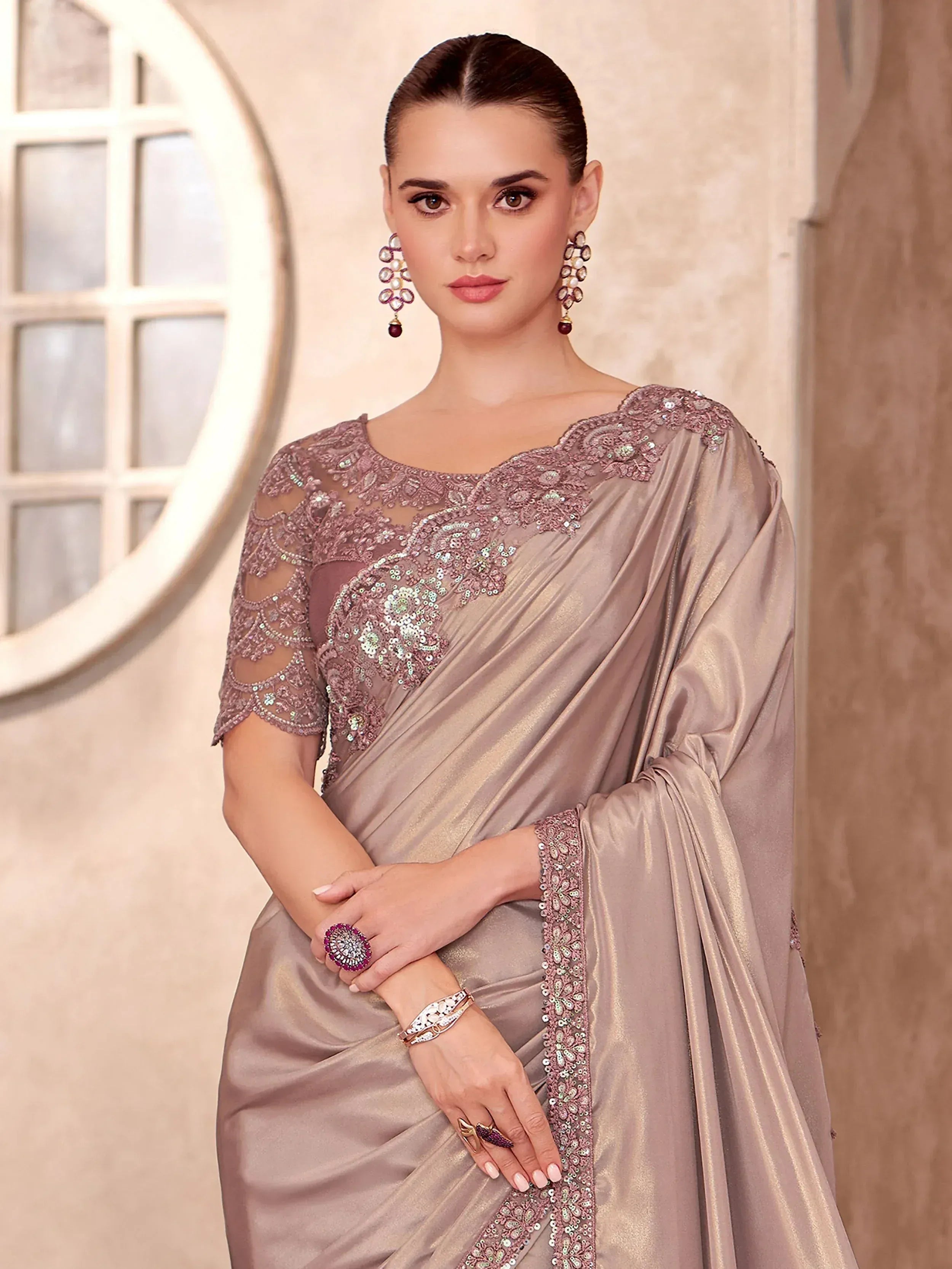 Elegant mauve saree with intricate sequin embroidery and sheer blouse, perfect for Indian ethnic occasions.