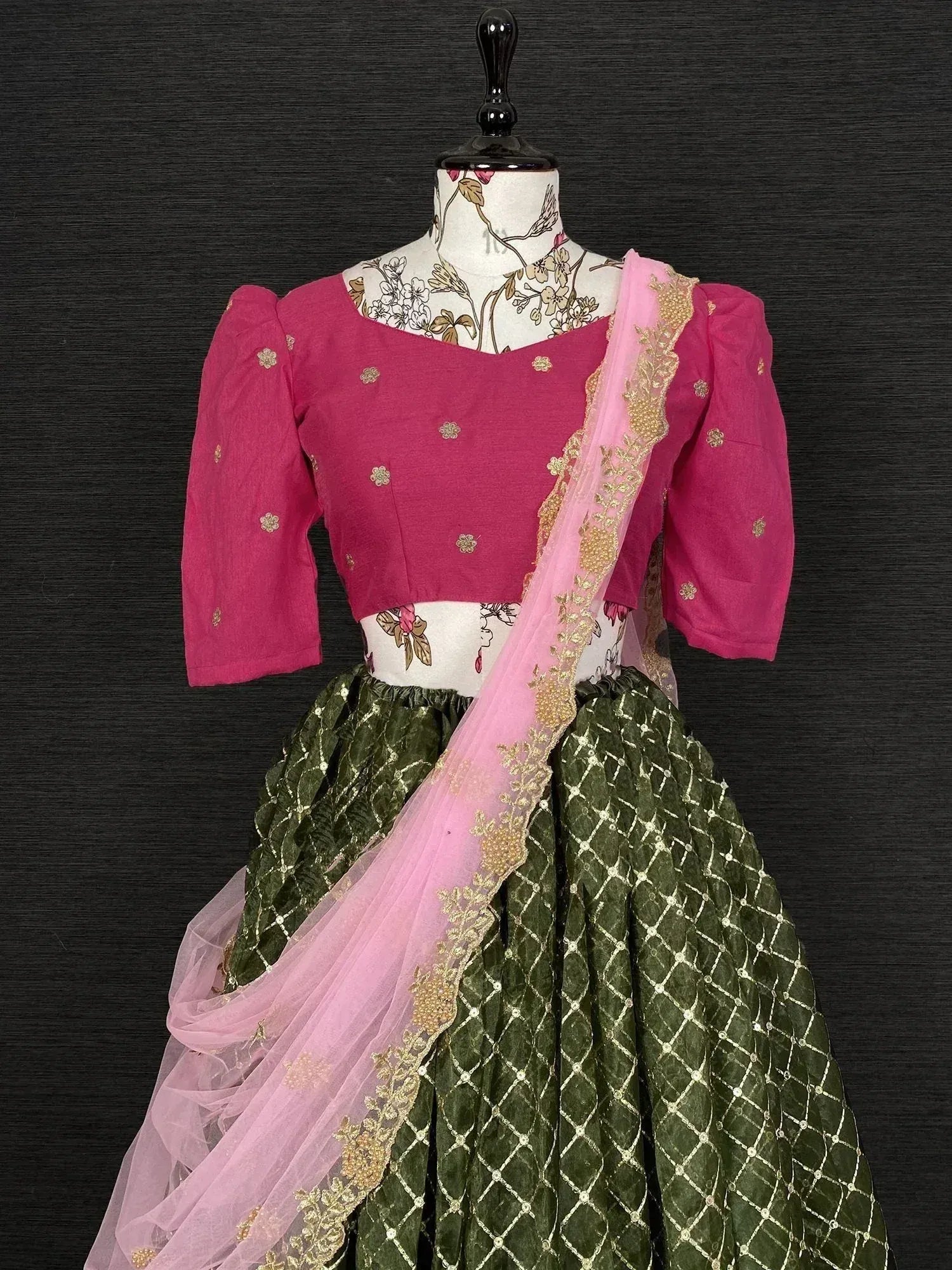 Pink and green designer lehenga choli with gold embroidery and sheer dupatta, perfect for ethnic occasions