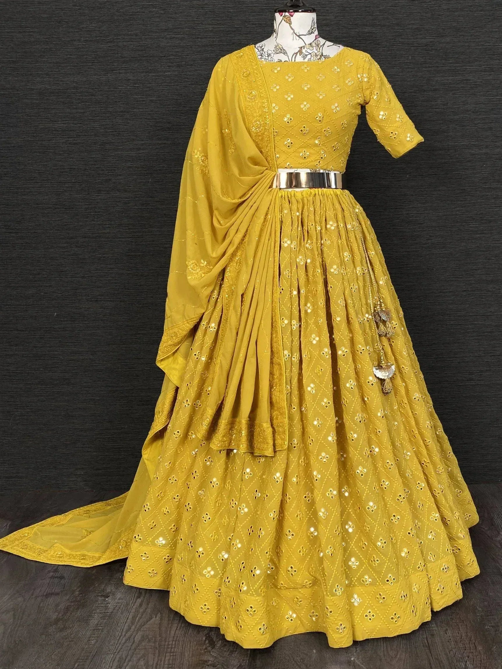 Mustard yellow designer lehenga choli with mirror work, dupatta, and metallic belt for Indian ethnic wear