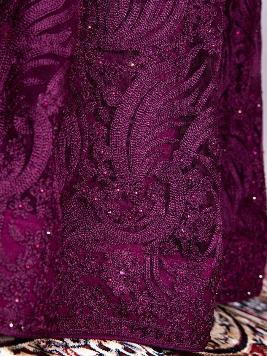 Rich purple ethnic gown with intricate embroidery and sequin detailing for festive occasions