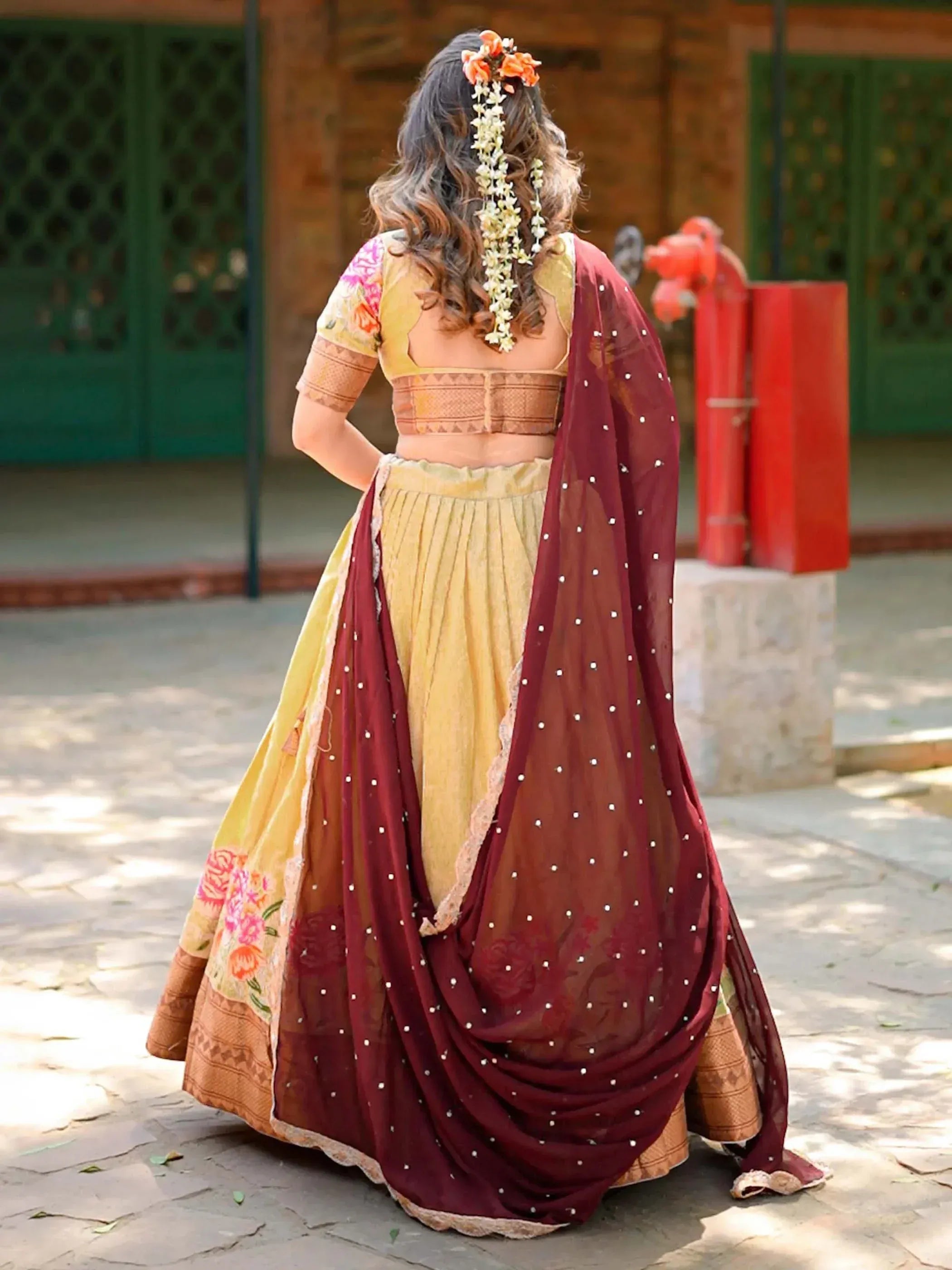 Yellow floral lehenga choli with maroon dupatta, perfect for Indian ethnic wear occasions
