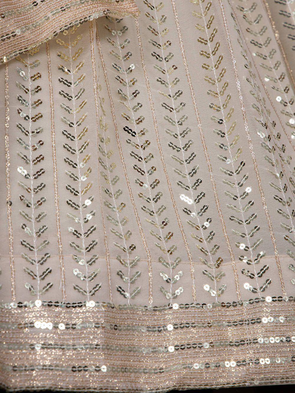Elegant beige lehenga with gold sequin leaf embroidery and shimmering border detail