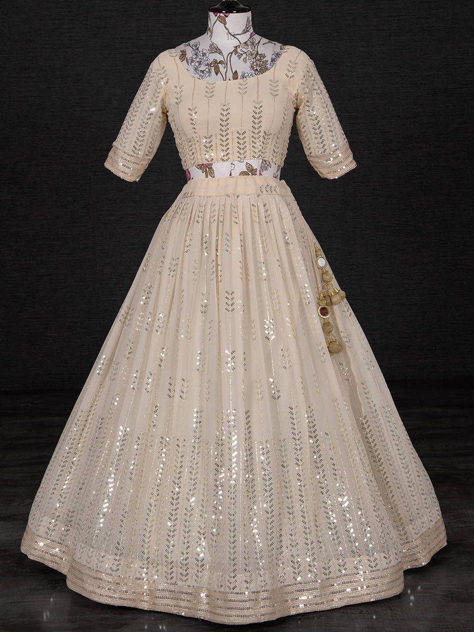 Cream sequin embroidered ethnic gown with floral neckline, perfect for Indian weddings and festive occasions.