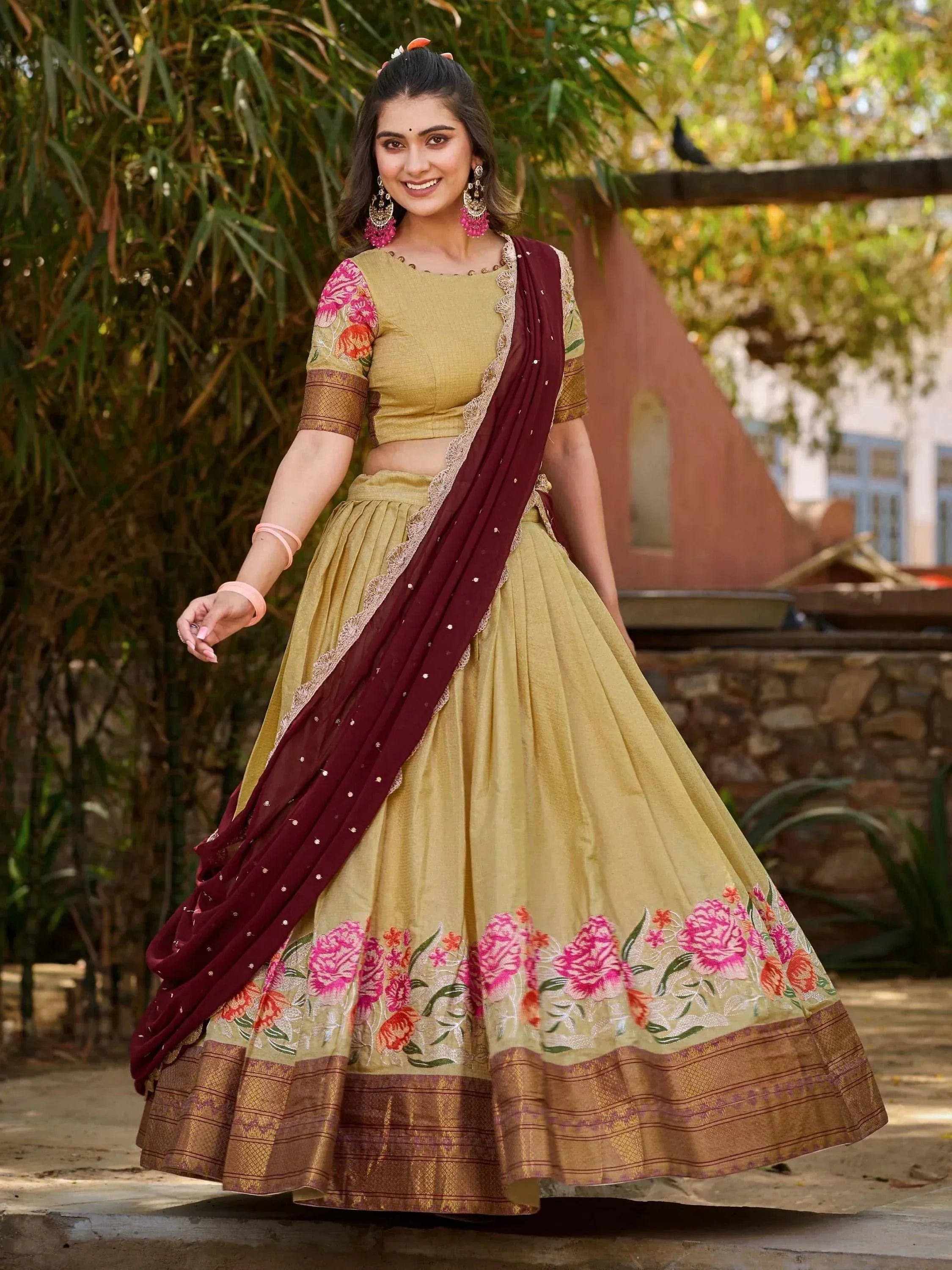 Elegant mustard lehenga choli with floral embroidery and maroon dupatta, perfect for Indian ethnic occasions.