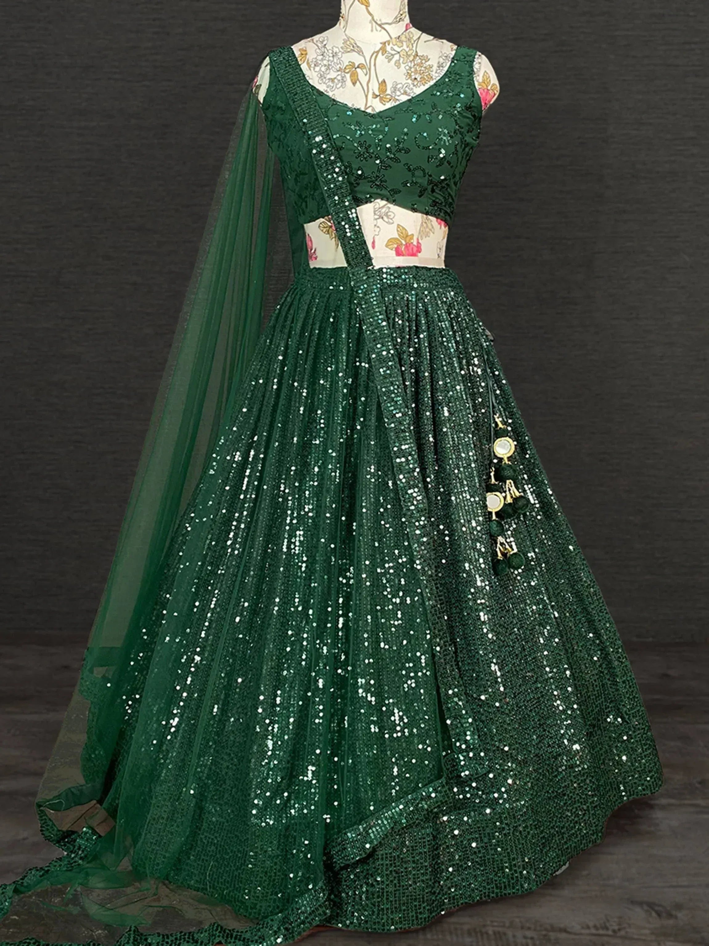 Emerald green sequin lehenga choli with sheer dupatta, perfect for Indian weddings and festive occasions.
