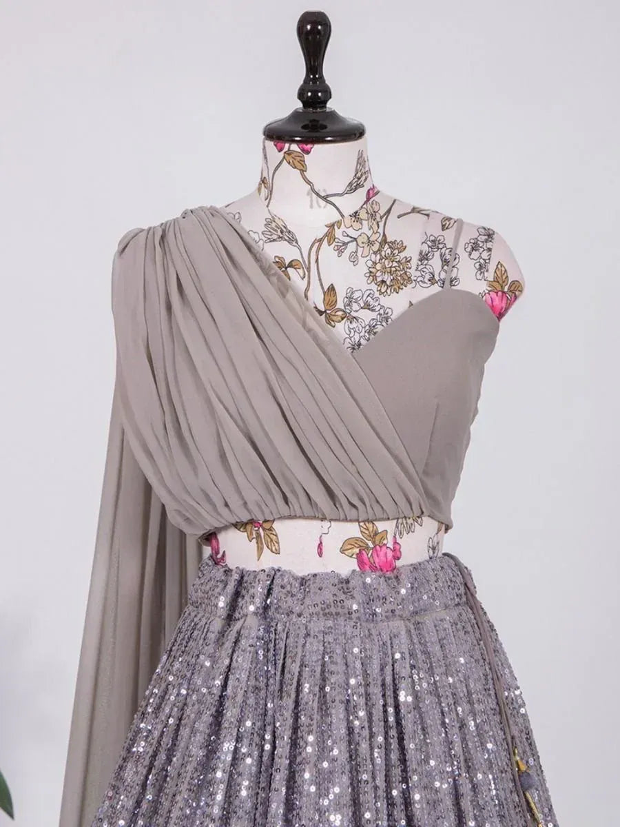 Grey pleated ethnic gown with sequin skirt and floral print bodice, perfect for Indian occasions