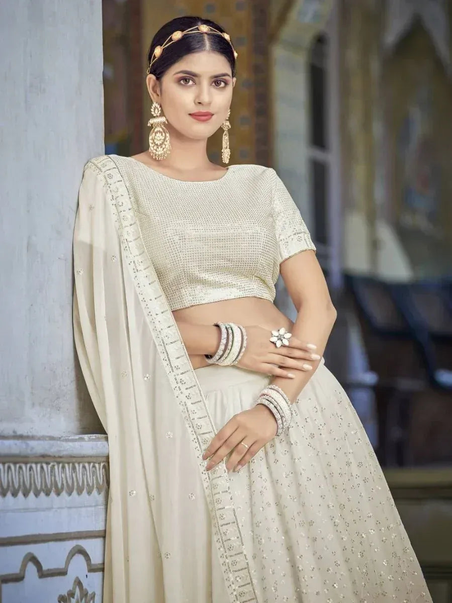 Elegant cream lehenga choli with intricate embroidery, perfect for Indian ethnic wear occasions.