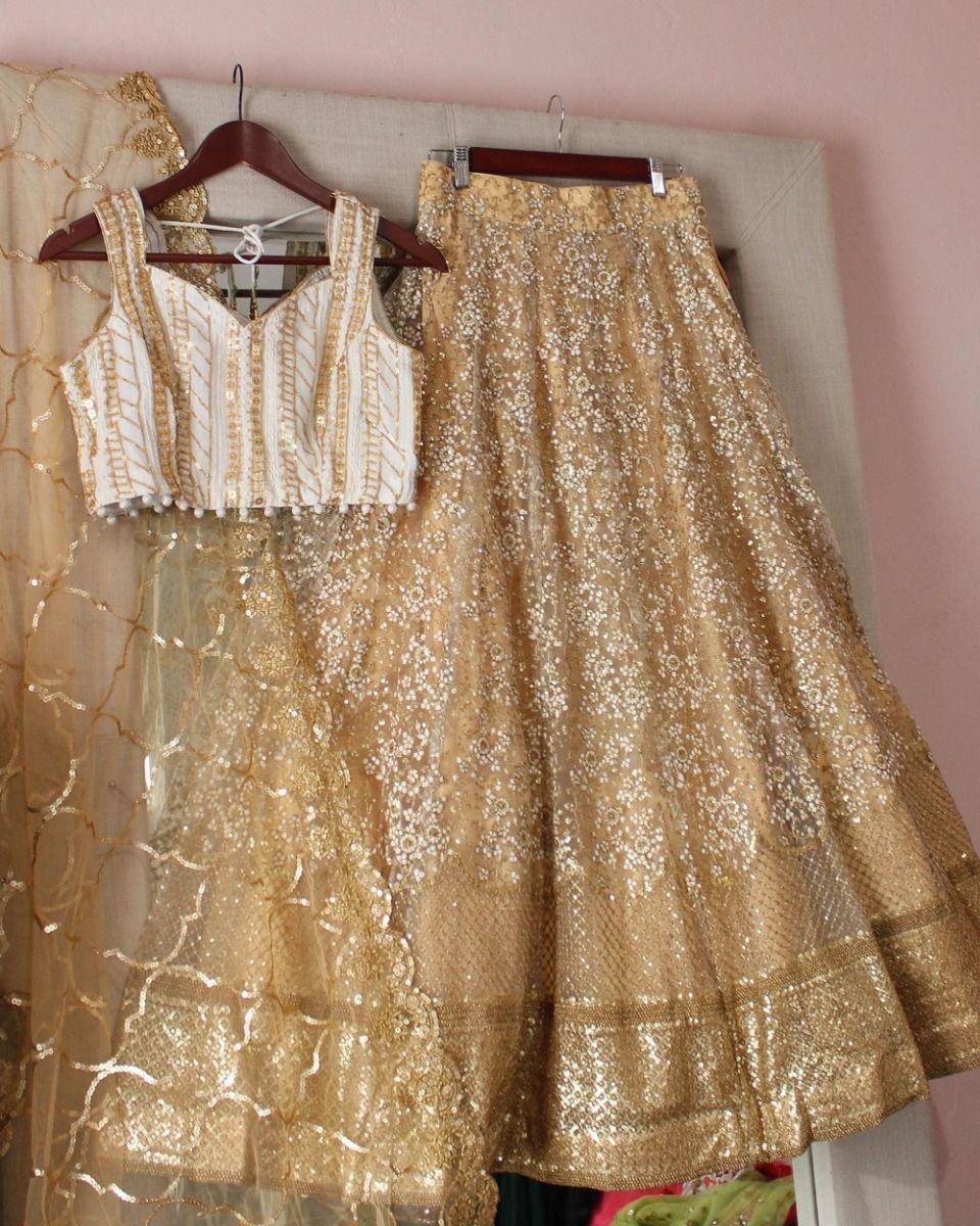 Gold embroidered lehenga choli with sequin work, perfect for Indian weddings and festive occasions