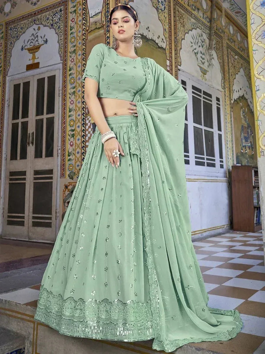 Mint green designer lehenga choli with floral embroidery and sequin detailing, perfect for Indian ethnic wear occasions.