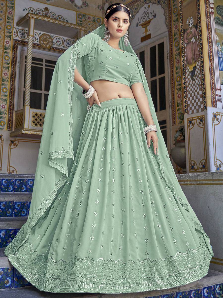 Mint green designer lehenga choli with floral embroidery and sequin detailing, perfect for Indian ethnic occasions.