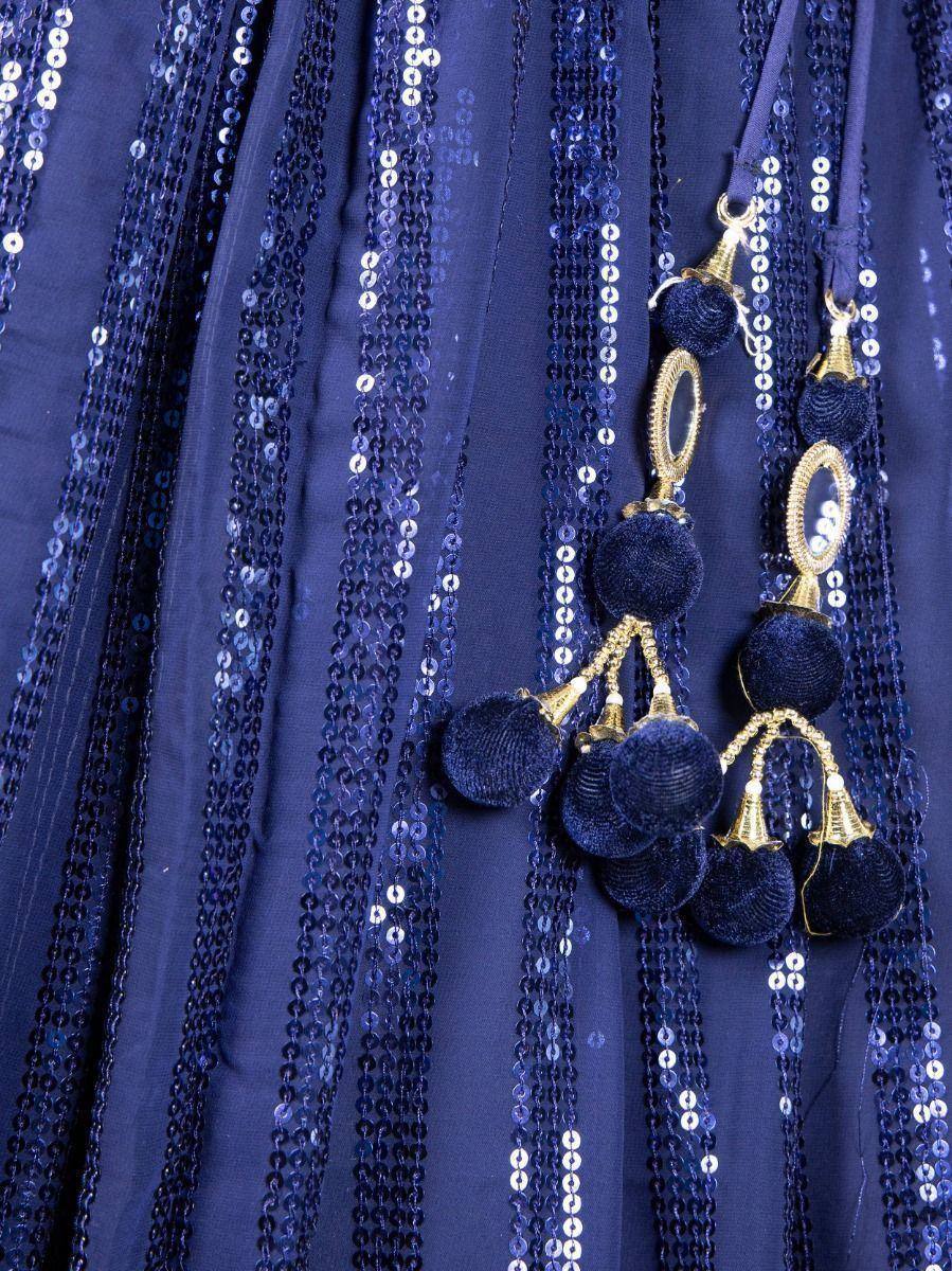Navy blue ethnic gown with sequin stripes and velvet tassels, perfect for festive occasions.