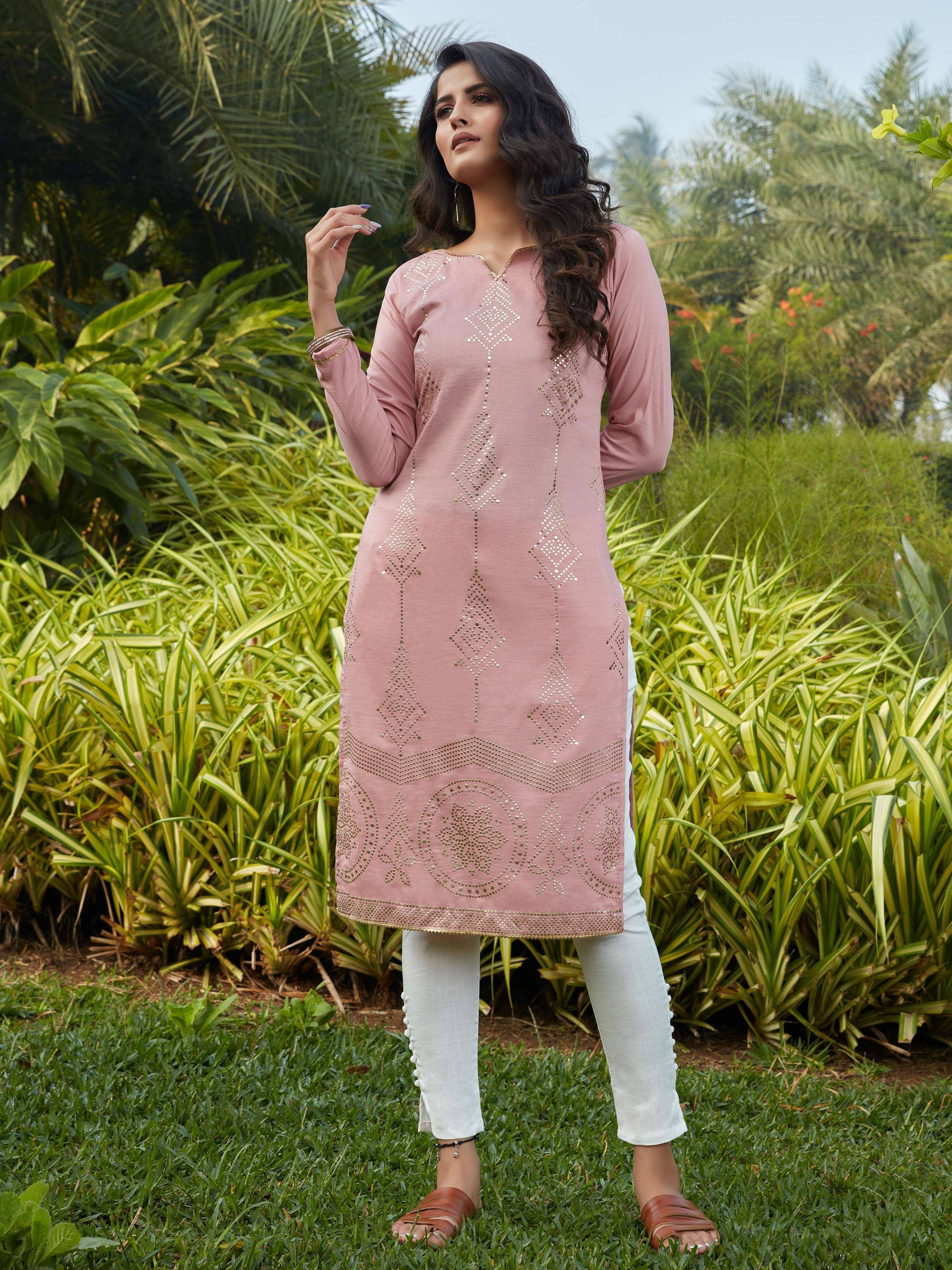 Pink embroidered kurta with white pants, ethnic Indian wear for women, garden setting