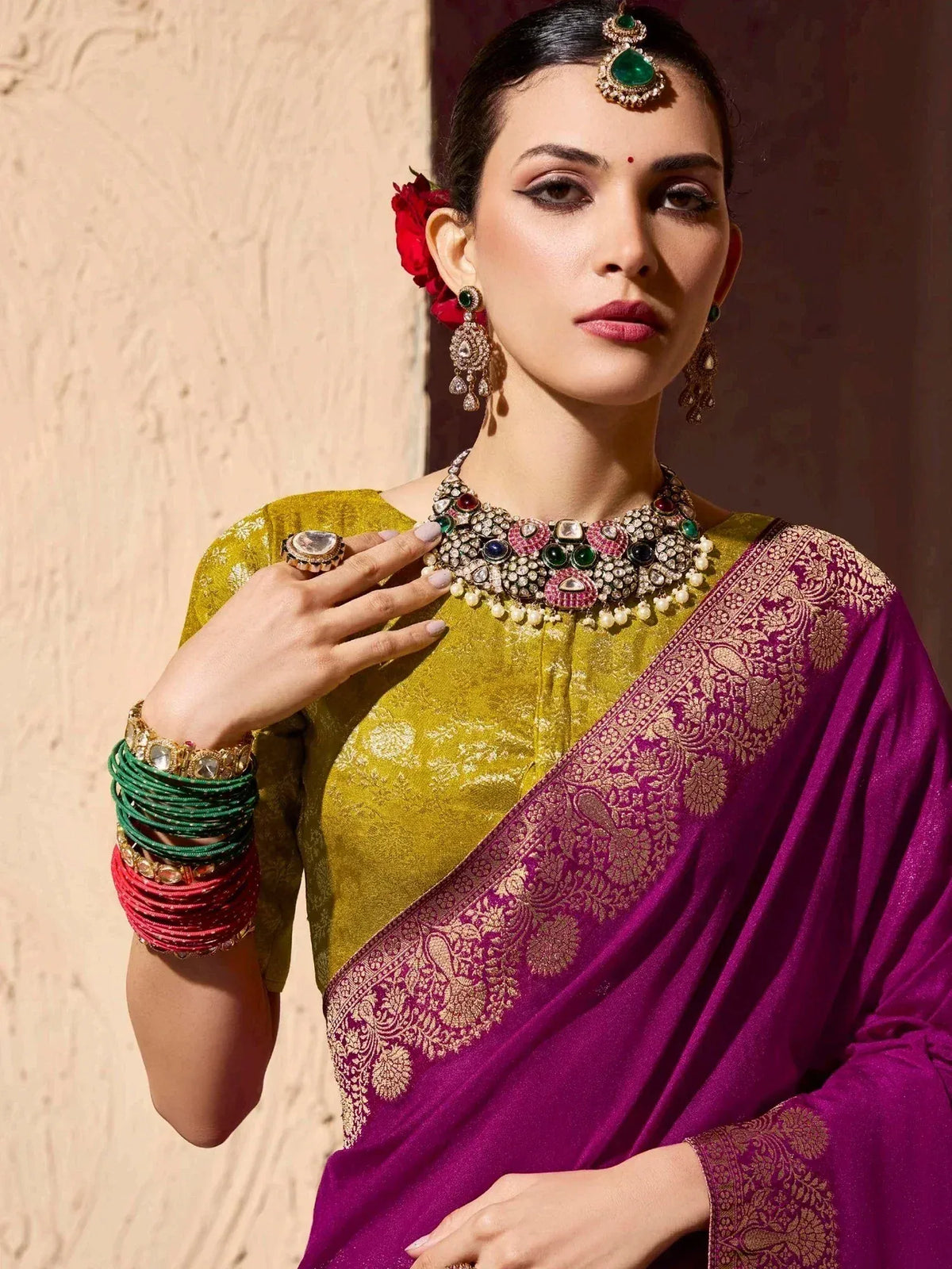 Woman in purple and gold saree with heavy jewelry, traditional Indian ethnic wear