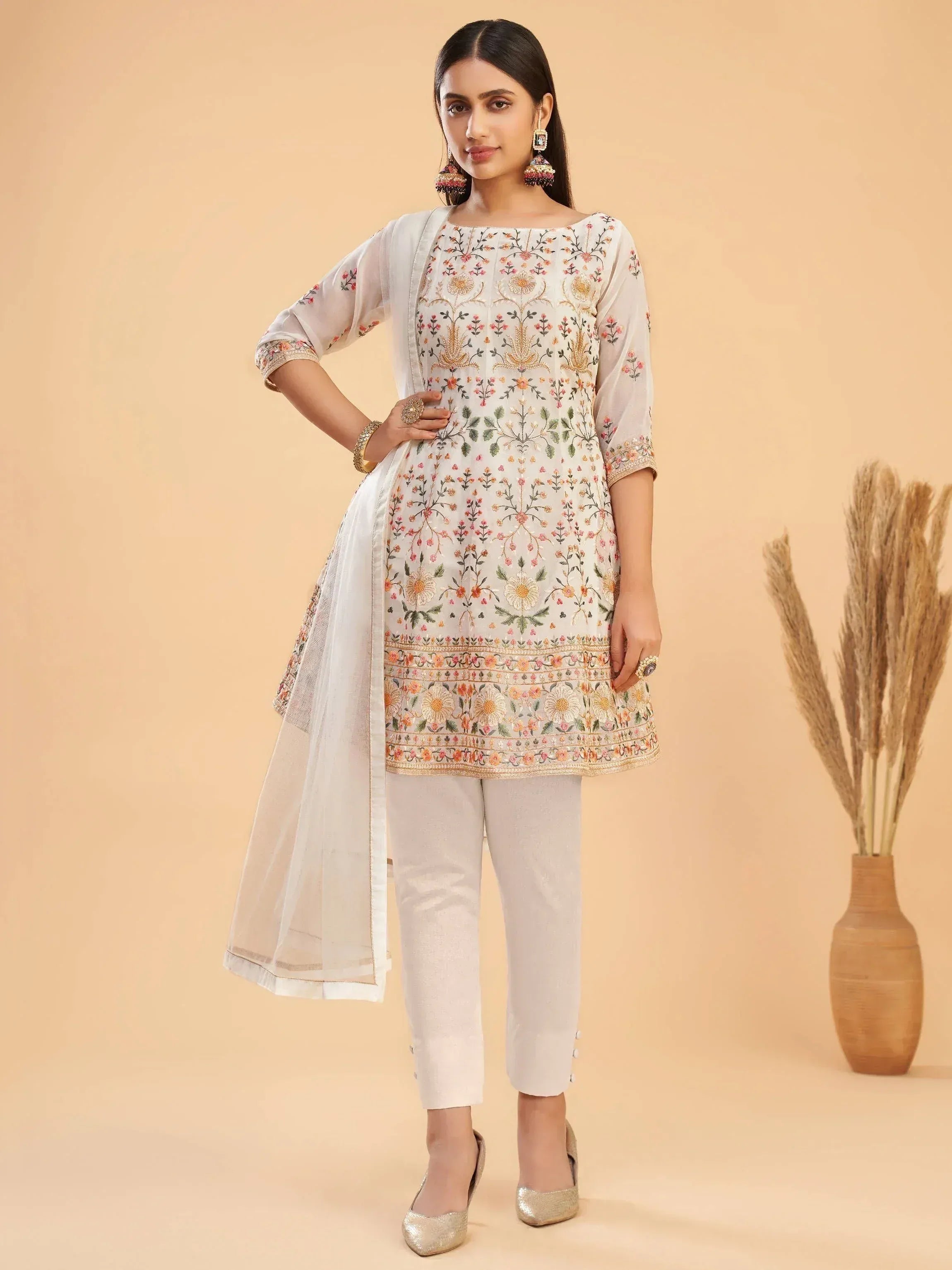 White embroidered kurta with floral design, paired with pants and dupatta, ethnic wear for women