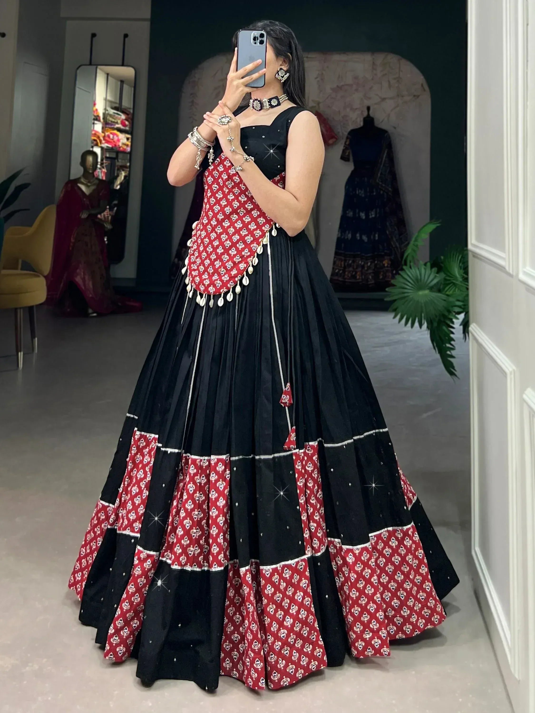 Black and red printed lehenga choli with mirror work, perfect for Indian ethnic wear occasions.