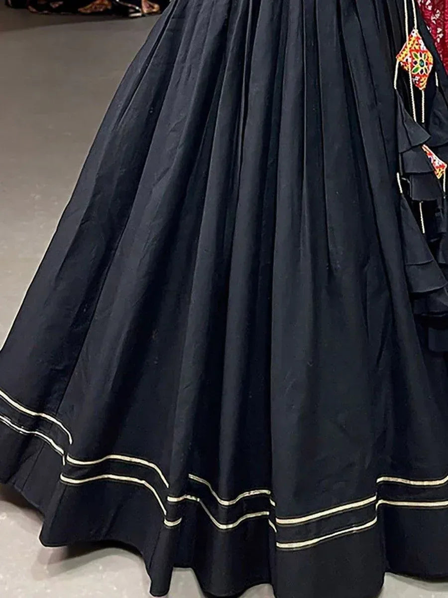 Black pleated lehenga skirt with gold trim and colorful embroidery, ethnic wear for women