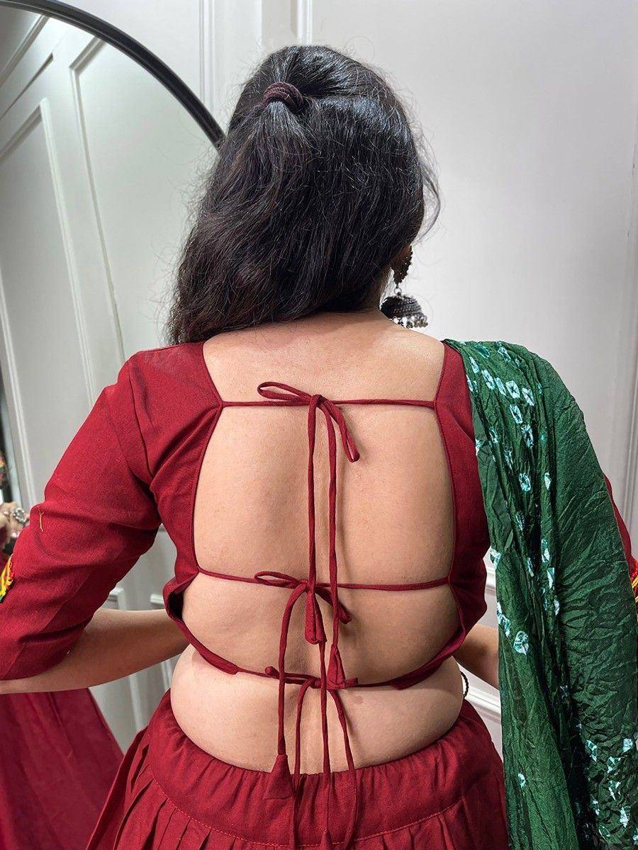 Back view of maroon ethnic blouse with crisscross tie-up back, paired with green dupatta