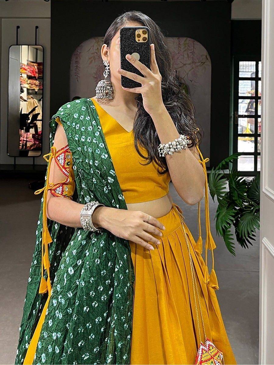 Woman in yellow lehenga choli with green printed dupatta, ethnic Indian wear