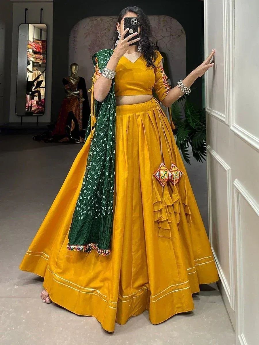 Yellow lehenga choli with green dupatta, ruffled skirt, and embroidered details for Indian ethnic wear