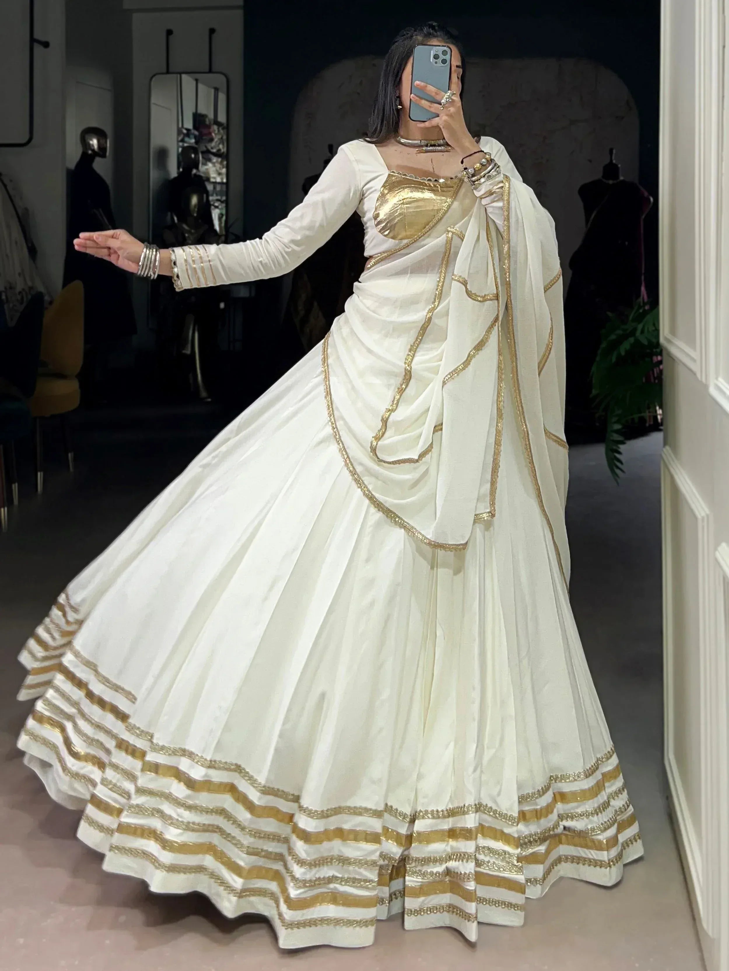 White and gold designer lehenga choli with intricate embroidery, perfect for Indian ethnic wear occasions.