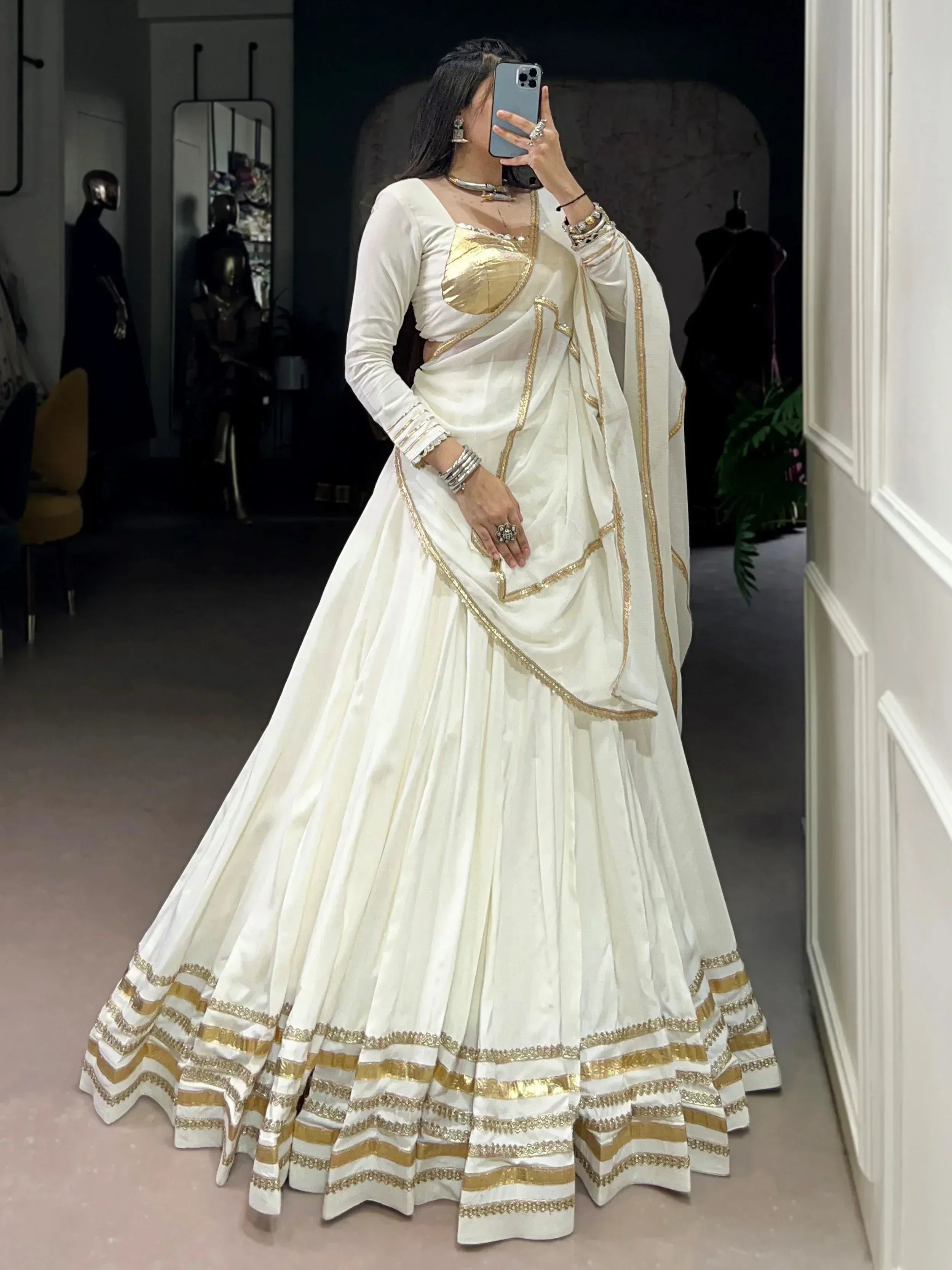White and gold lehenga choli with embroidered border, perfect for Indian ethnic wear occasions