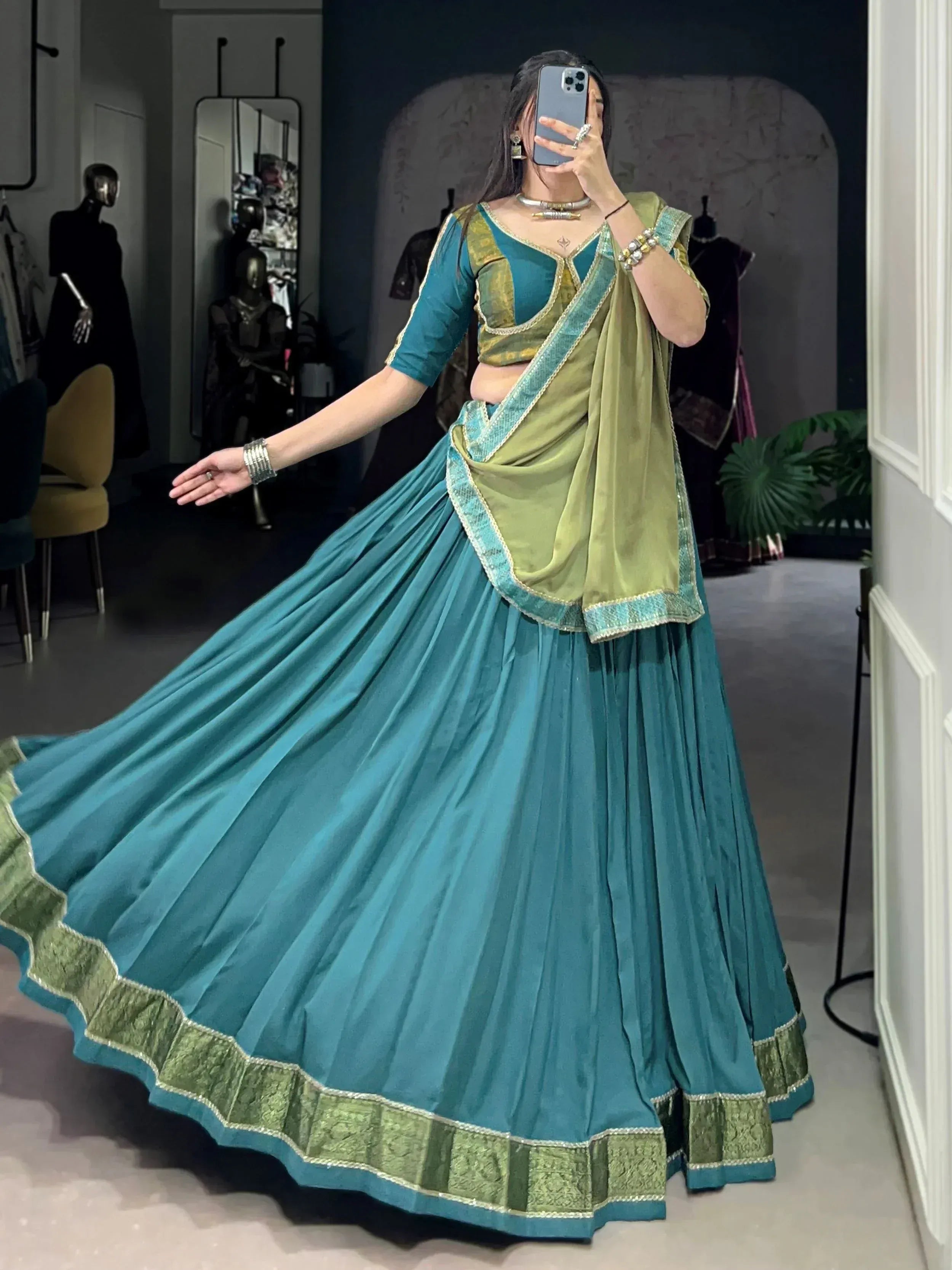Teal and olive green designer lehenga choli with pleated skirt and embroidered dupatta, perfect for Indian ethnic wear.
