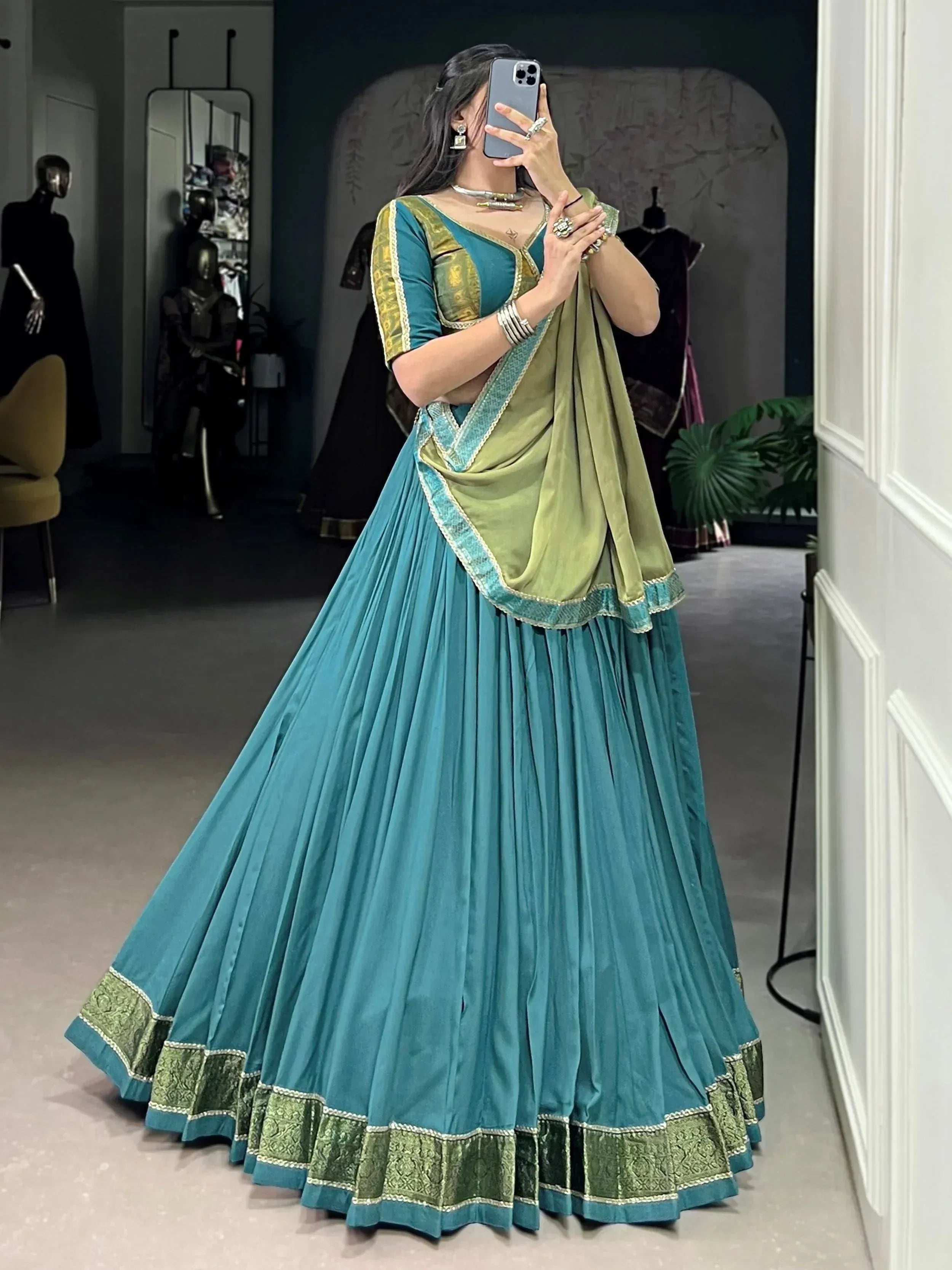 Teal and olive green designer lehenga choli with embroidered borders, perfect for Indian ethnic wear events