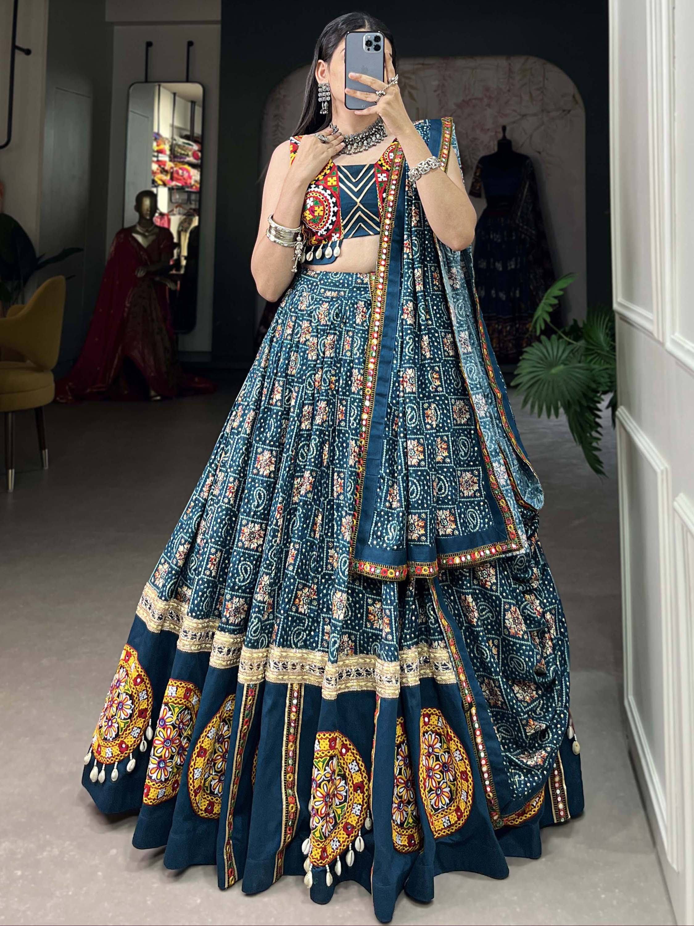 Blue embroidered lehenga choli with mirror work, floral patterns, and traditional Indian ethnic wear design