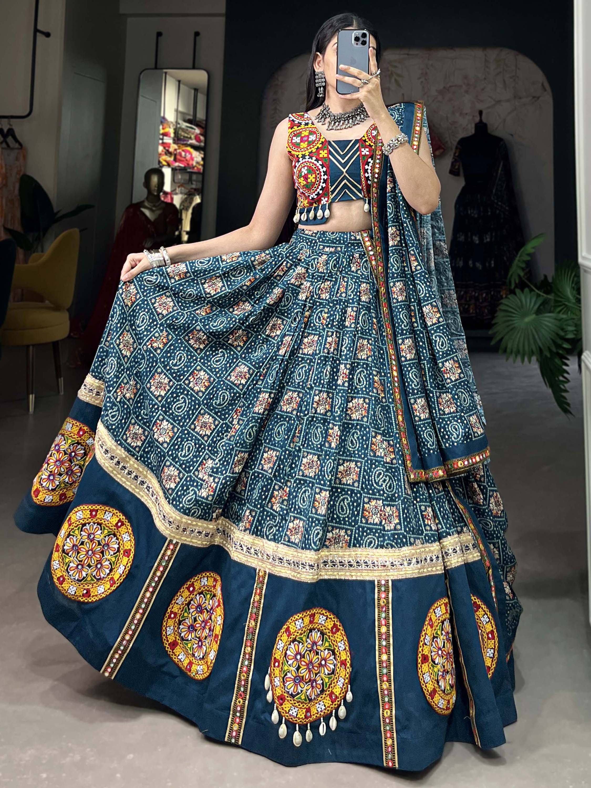Blue embroidered lehenga choli with mirror work, floral motifs, and traditional Indian ethnic wear design
