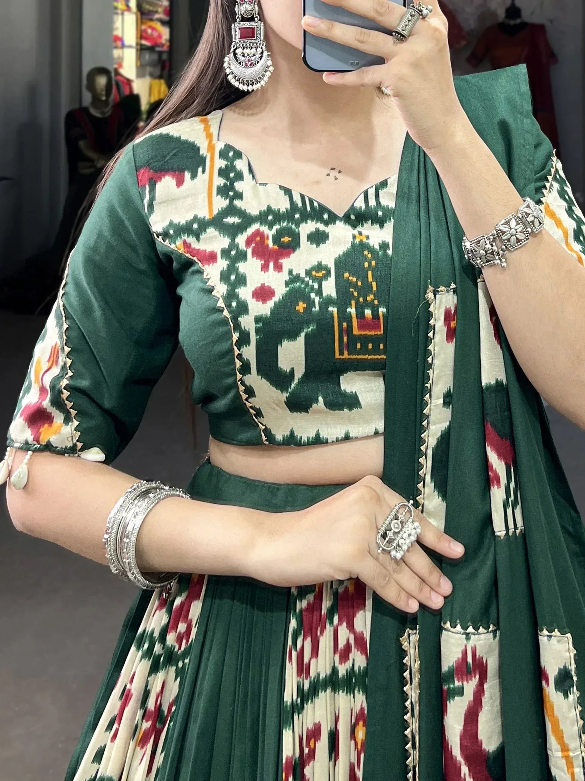 Green Ikat printed lehenga choli with elephant motif, traditional Indian ethnic wear, paired with silver jewelry