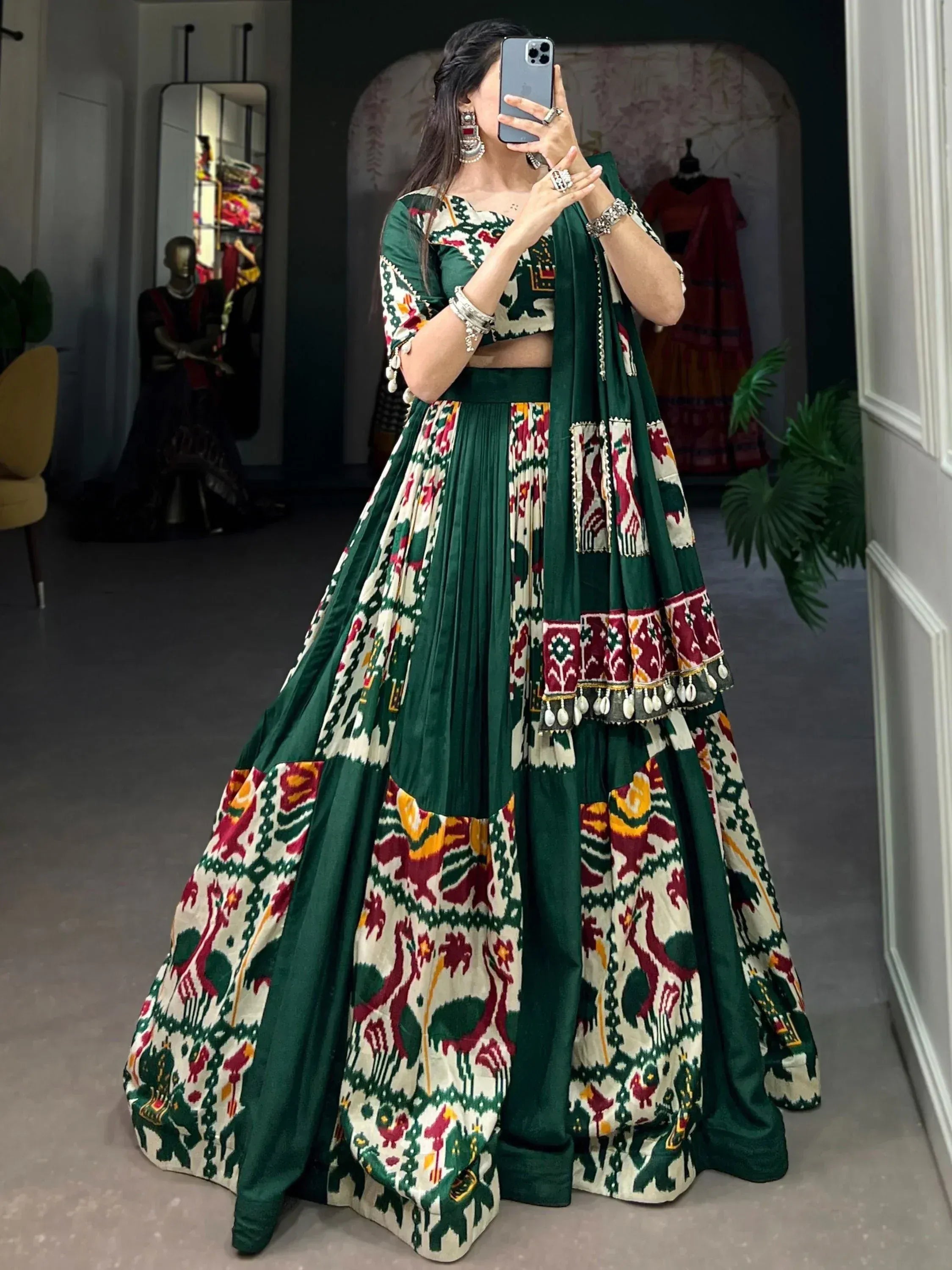 Green and cream printed lehenga choli with ethnic embroidery and mirror work, perfect for Indian weddings and festive occasions.