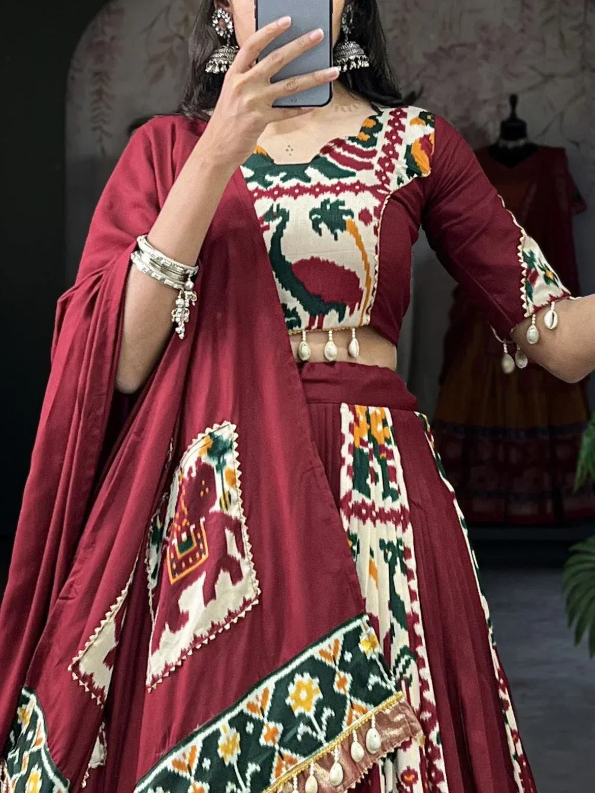 Maroon ethnic lehenga choli with peacock and elephant ikat print, perfect for Indian festive occasions